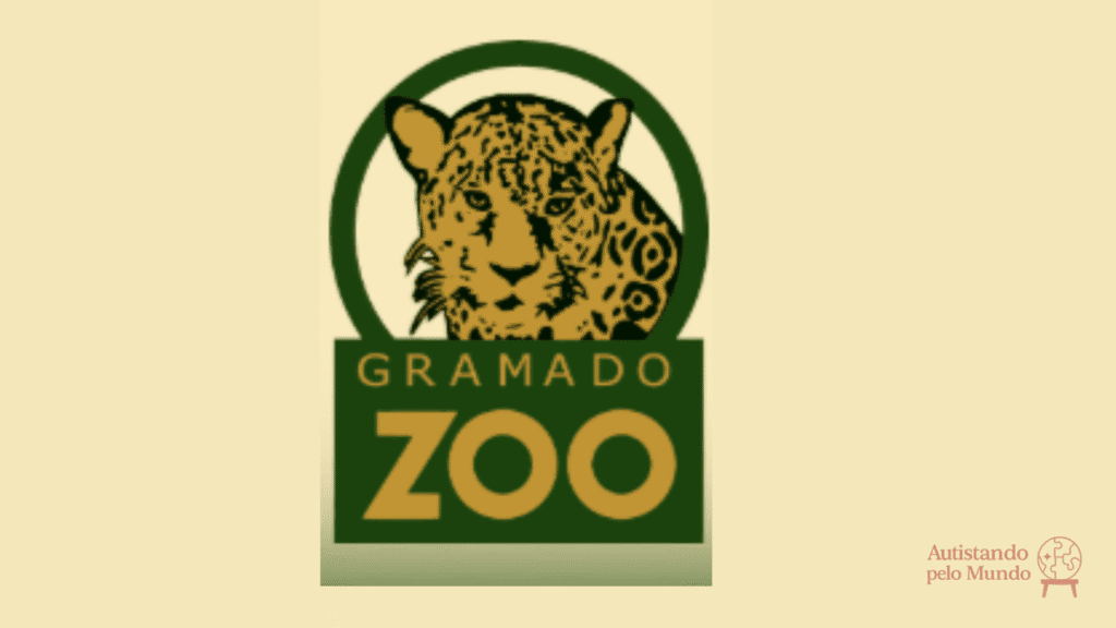 Logotipo do Gramado Zoo com uma onça-pintada centralizada em fundo amarelo e selo do Autistando pelo Mundo no canto inferior direito.